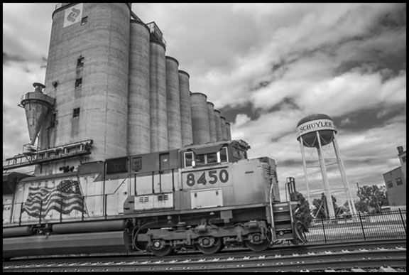 SCHUYLER, NE - 25SEPTEMBER16 - Grain silos and a train in Schuyler, a small meatpacking town in Nebraska. Copyright David Bacon