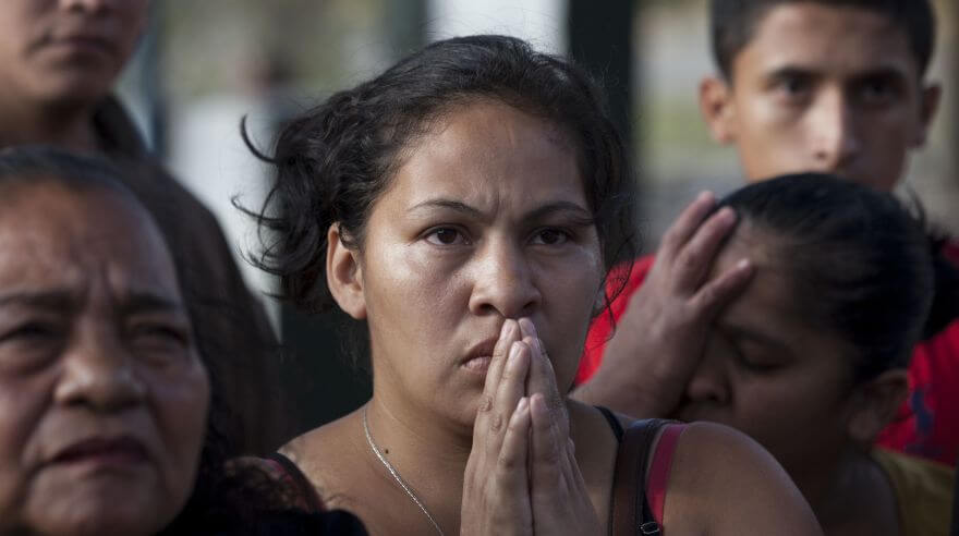 Relatives listen for new information about the injured after a fire, as they gather outside the children's shelter Virgin of the Assumption Safe Home, in San Jose Pinula, Guatemala, Wednesday, March 8, 2017. At least 19 girls have died after a fire at the shelter, which was created to house children who were victims of abuse, homelessness or who had completed sentences at youth detention centers and had nowhere else to go, the spokesman for Guatemala's volunteer fire departments said. (AP Photo/Moises Castillo)